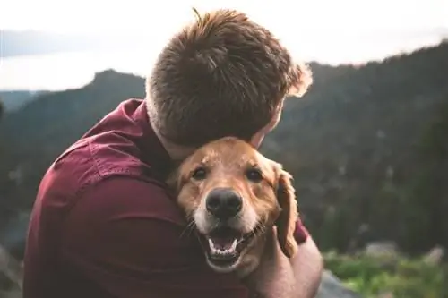 un hombre abrazando a un perro