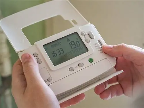 taong nag-aayos ng thermostat